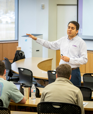 Professor teaches in front of class.