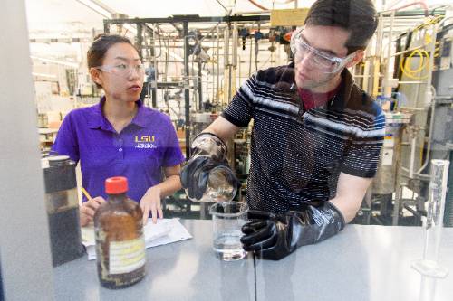 Student pours from one beaker to another 