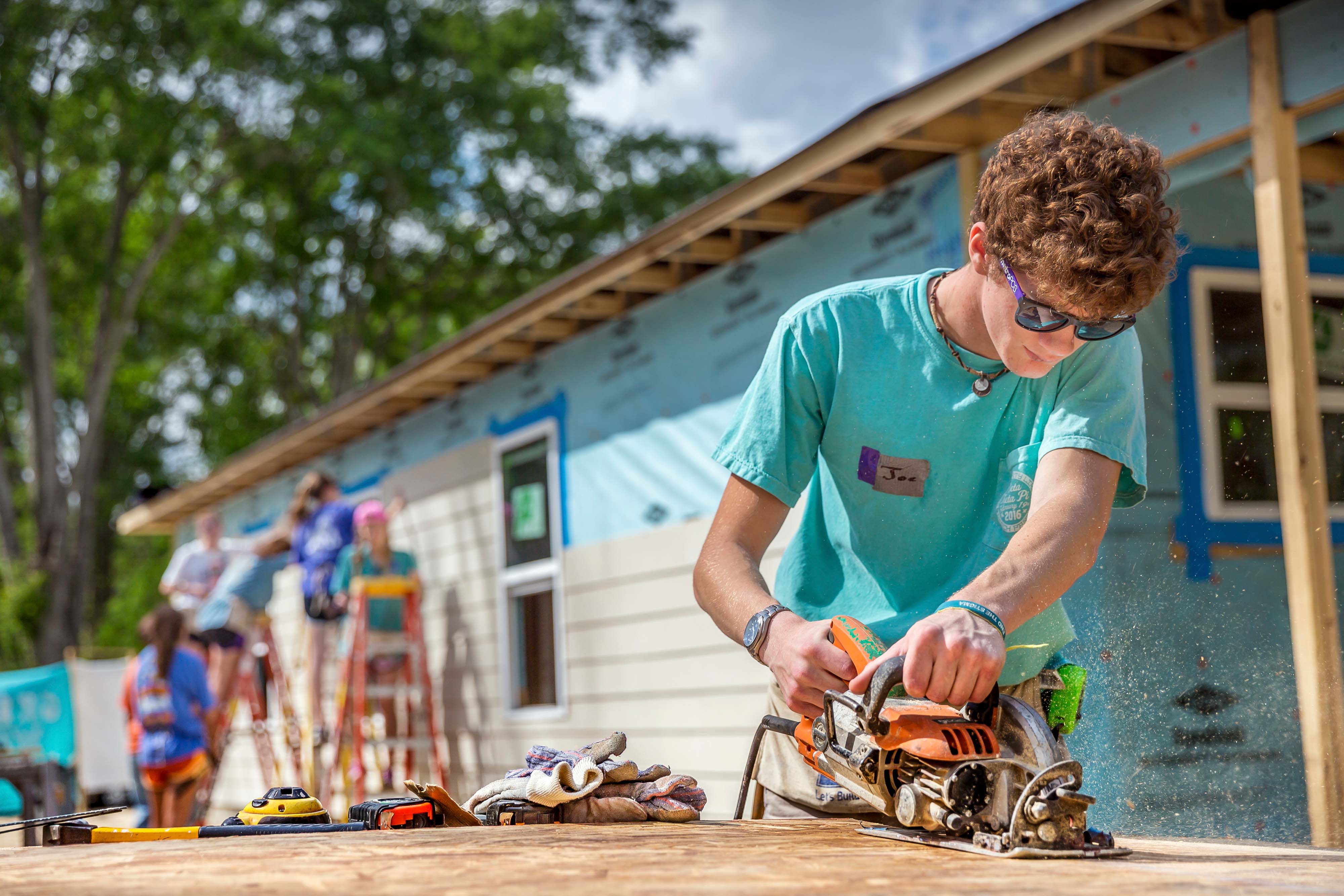 fraternity member volunteering in construction