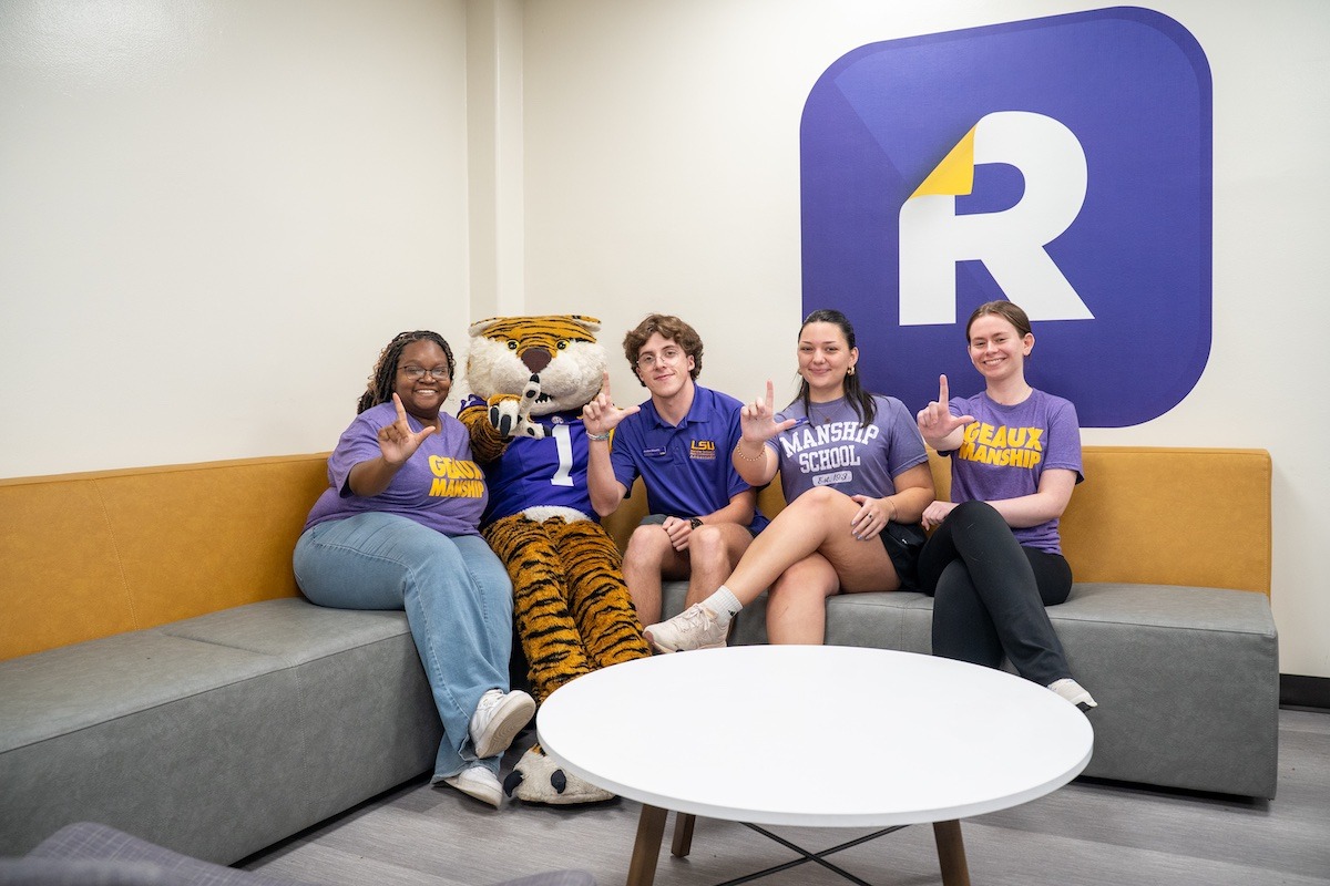 Students sitting with Mike the Tiger mascot