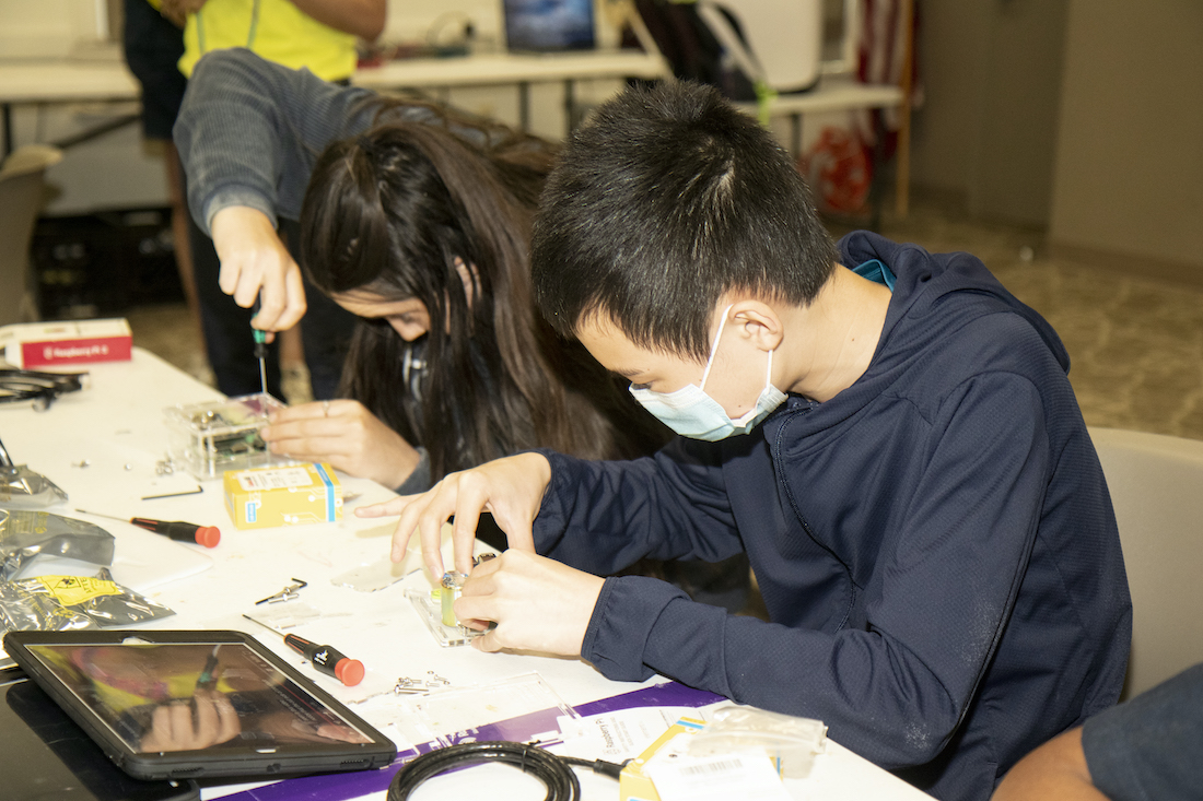 Two participants of LSU Science Our Earth, Our Lab work on their seismographs.