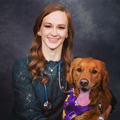 Peyton poses with a dog. 